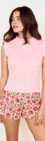 Model wearing Linen Blend Shirred Top in Baby Pink with floral shorts, showcasing a feminine summer look.