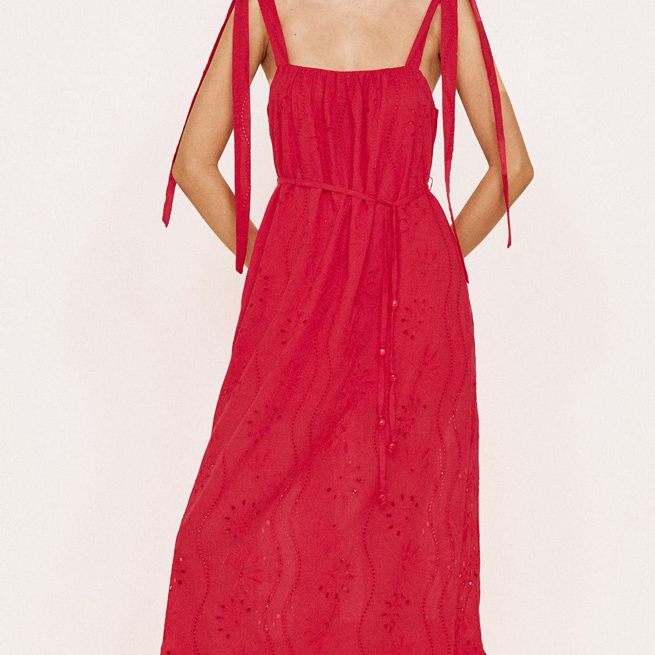 Cotton Broderie Maxi Sun Dress in Red worn by a model with tie shoulder straps and flowing silhouette.