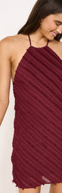 Fringe Detail Halter Mini Dress in Wine worn by a model, showcasing its textural fringe and halter neckline.