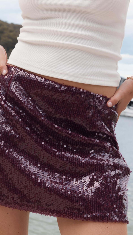 Purple Sequin Mini Skirt featuring a deep burgundy sequin fabric, perfect for parties and celebrations.