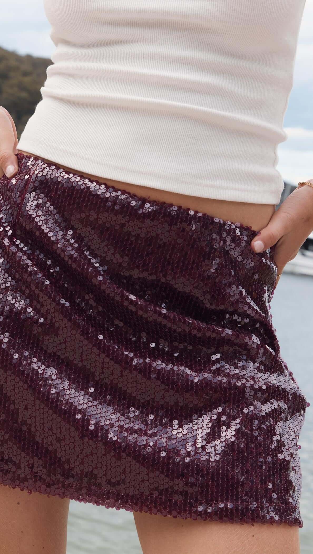 Purple Sequin Mini Skirt featuring a deep burgundy sequin fabric, perfect for parties and celebrations.