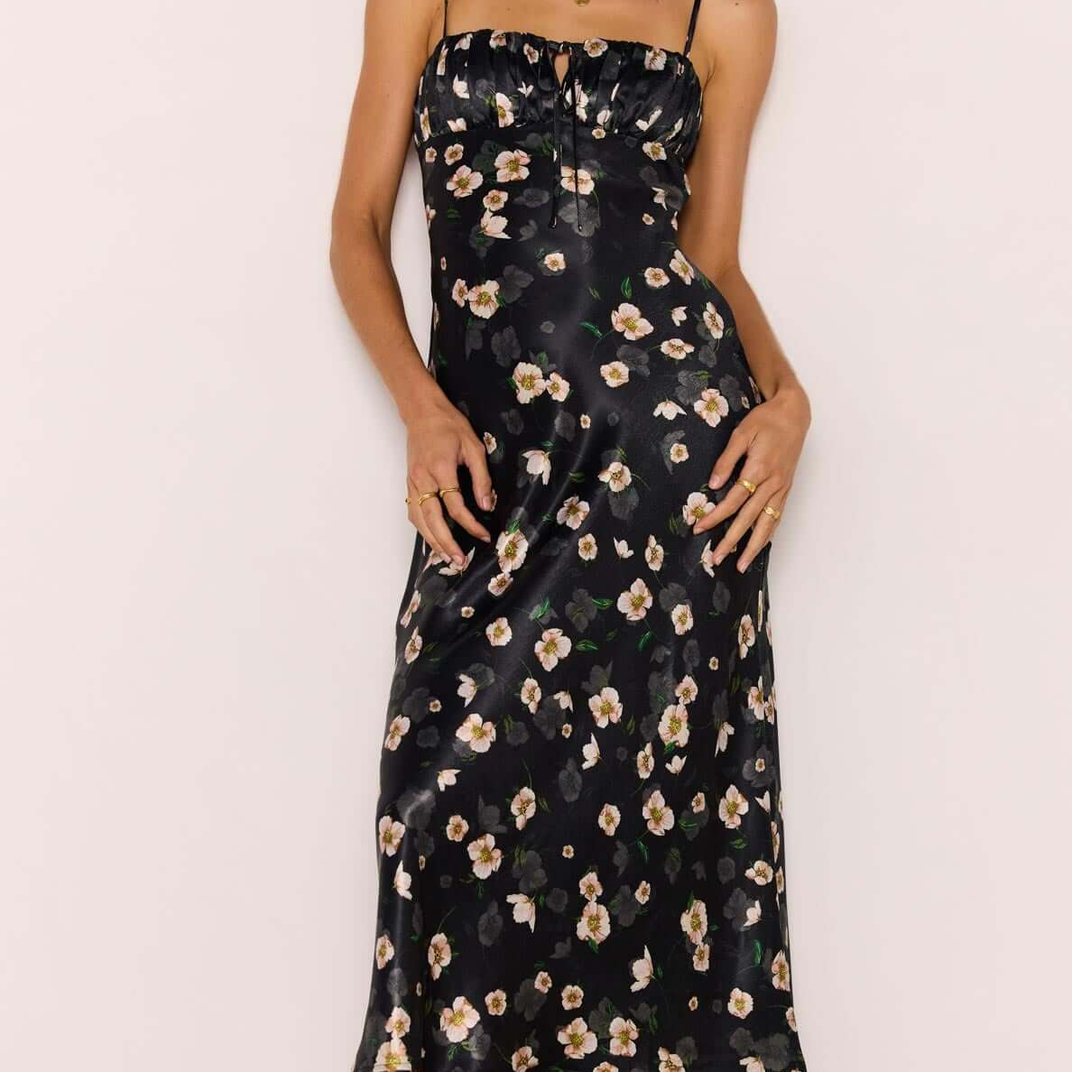Black Floral Bias Midi Dress showcased on a model, featuring a soft satin finish and flattering bias cut.