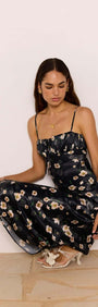 Black Floral Bias Midi Dress worn by model, featuring a ruched bust and keyhole tie detail, perfect for special occasions.