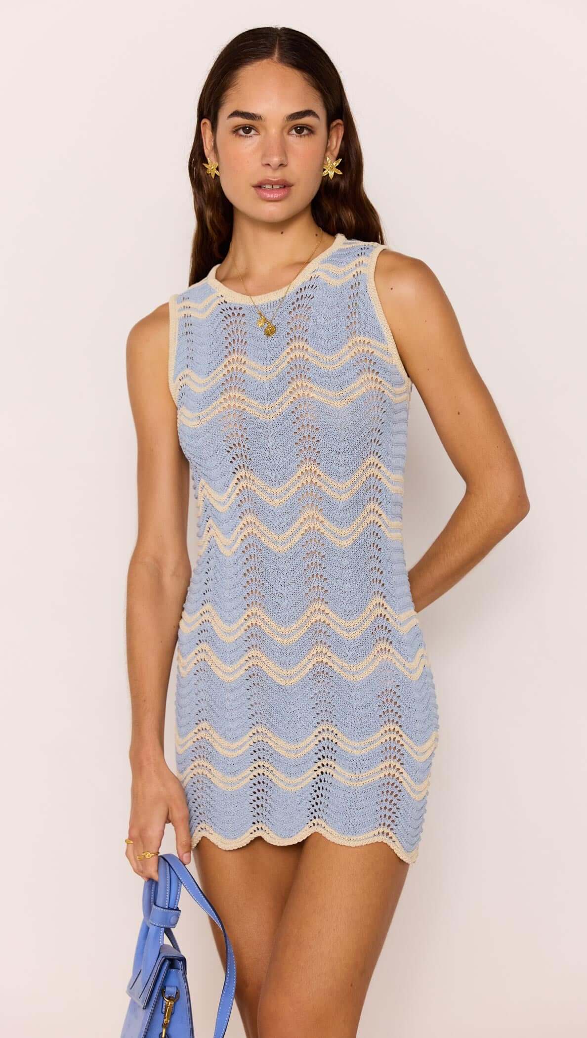 Model wearing a Blue & Cream Knit Mini Dress with a soft wave knit pattern and scalloped hem.
