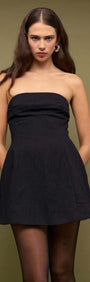 Black Strapless Peplum Mini Dress on model with a structured fit-and-flare silhouette, perfect for evening occasions.