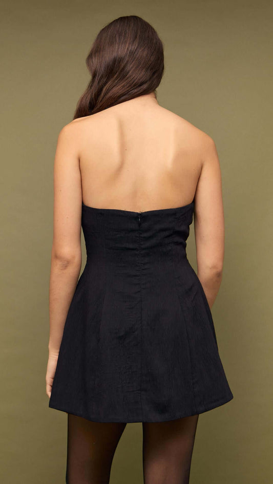 Back view of a Black Strapless Peplum Mini Dress highlighting its sleek silhouette.