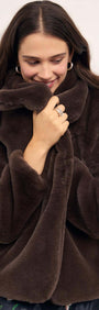 A model wearing a cozy Brown Faux Fur Coat, showcasing its soft texture and oversized collar.