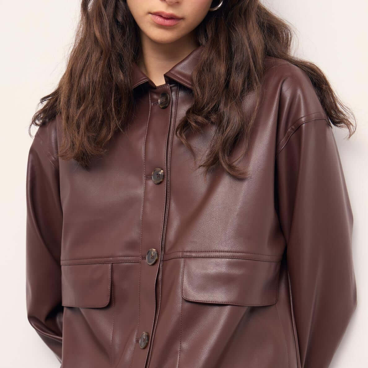 Brown Faux Leather Jacket worn by a model, featuring button-front closure and statement pockets, showcasing a relaxed silhouette.