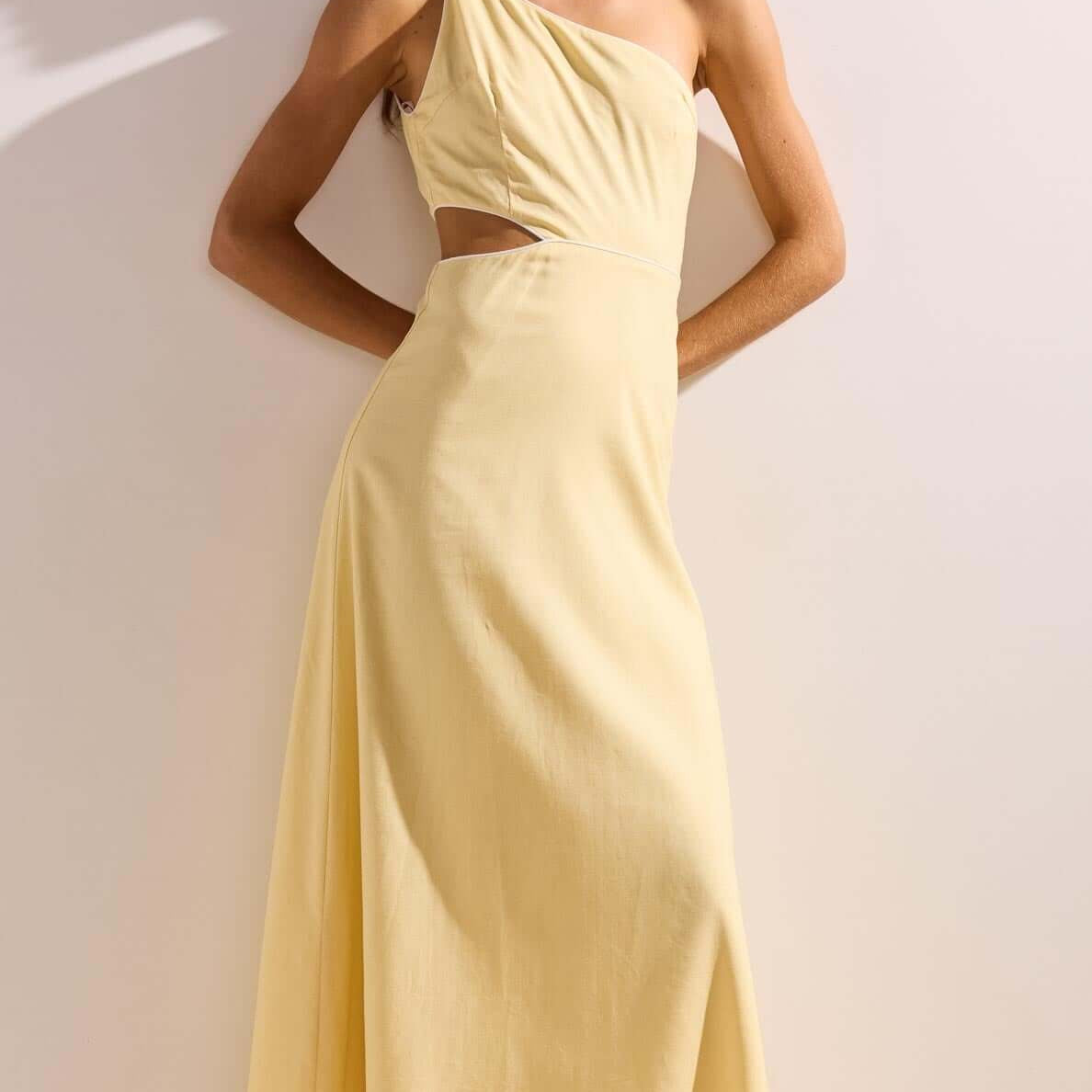 Butter Yellow Asymmetric Cut Out Maxi Dress featuring a one-shoulder neckline and subtle waist cut-out