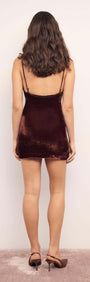 Model showcasing the back view of the Chocolate Velvet V-Neck Mini Dress in rich chocolate velvet.
