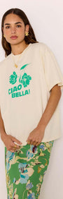 Ciao Bella Relaxed Cotton Oversized Tee featuring bold green print on soft cotton, styled with a floral skirt.