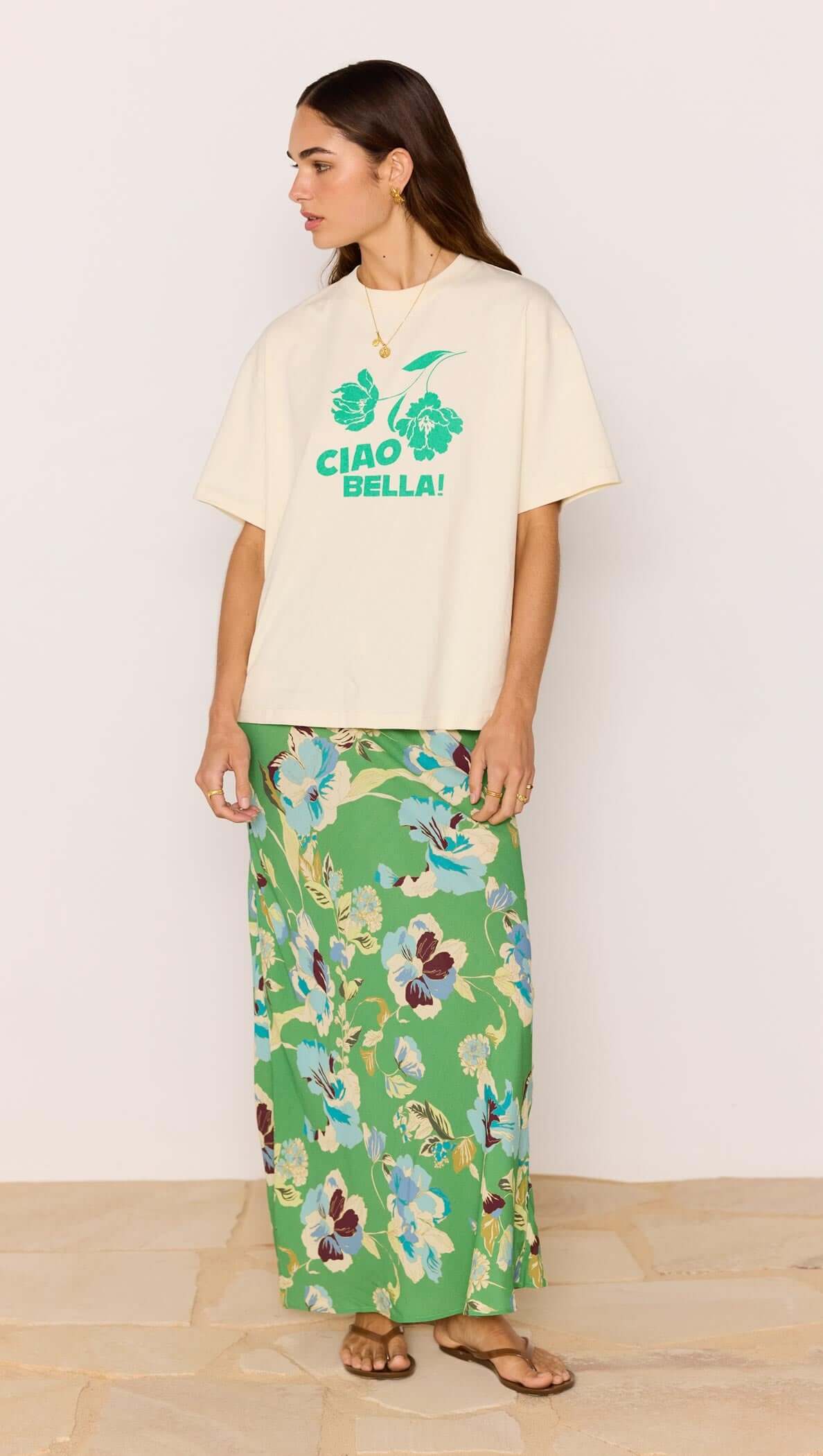 Model wearing Ciao Bella Relaxed Cotton Oversized Tee with floral print skirt, showcasing summer style.