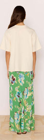 Back view of model wearing Ciao Bella Relaxed Cotton Oversized Tee with floral green maxi skirt.