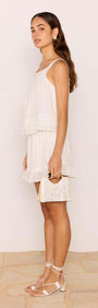 Model wearing a Lace Detail White Cotton Mini Skirt paired with a matching top, showcasing a relaxed summer style.