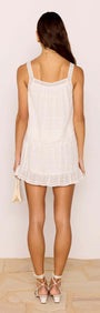 Back view of a model wearing a Lace Detail White Cotton Mini Skirt, showcasing its relaxed fit and frill hem.