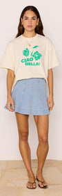 Model wearing a denim flared mini skirt with a graphic tee, showcasing a stylish summer outfit.