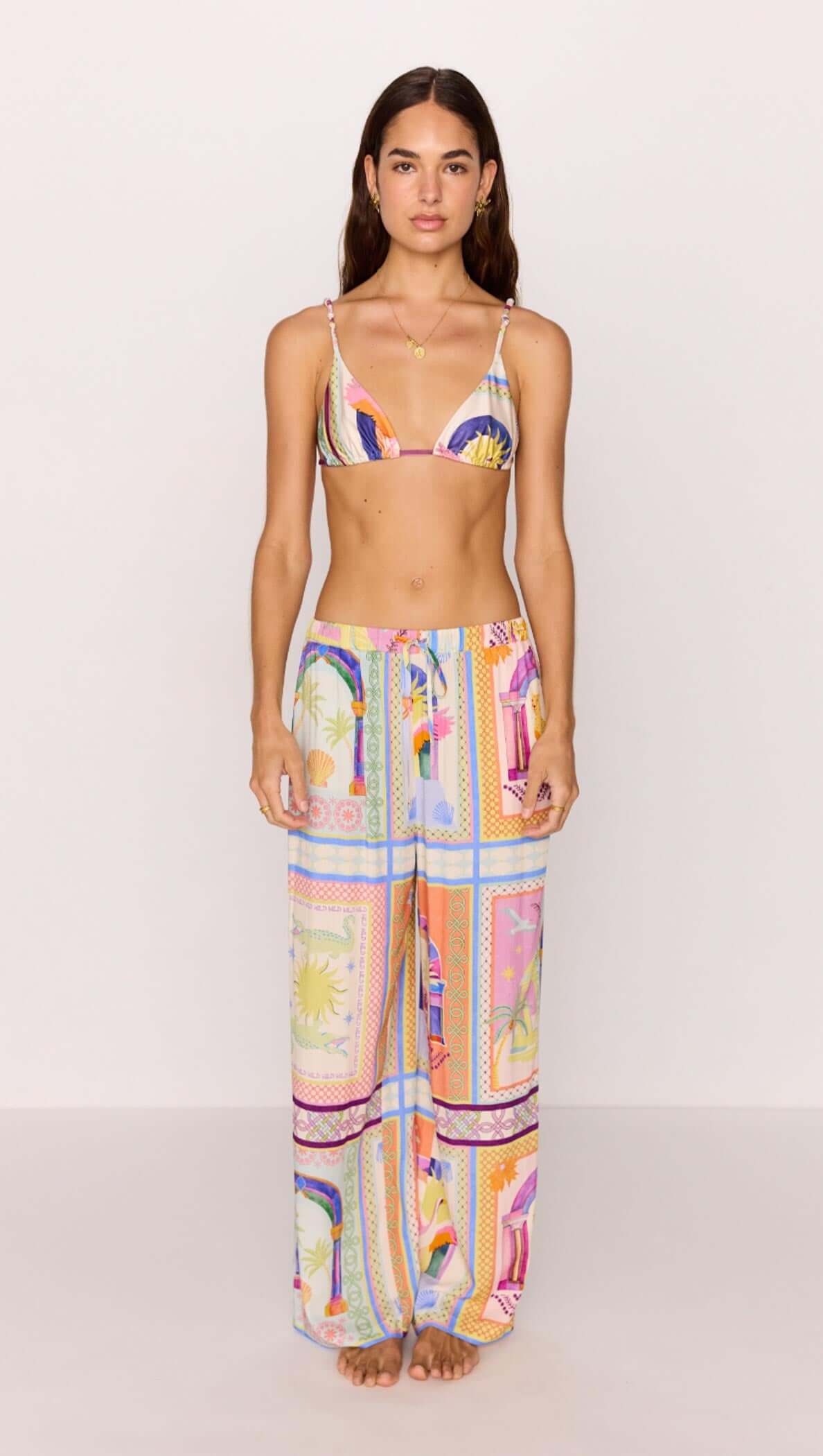 Model wearing a multicolour printed drawstring wide-leg pant with matching bikini top, perfect summer outfit.
