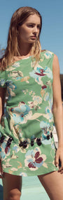 Model in Green Floral Asymmetric Mini Dress by Zoe, featuring a one-shoulder design and a vibrant floral print.