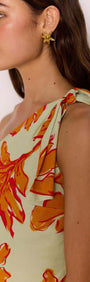 Close-up of model wearing Green & Orange Floral Asymmetric Mini Dress showcasing one-shoulder design and floral print.
