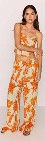 Model wearing Green & Orange Floral Drawstring Wide Leg Pant with matching top, showcasing vibrant floral design.