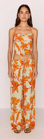 Model wearing Green & Orange Floral Drawstring Wide Leg Pant with matching top, showcasing vibrant floral print.
