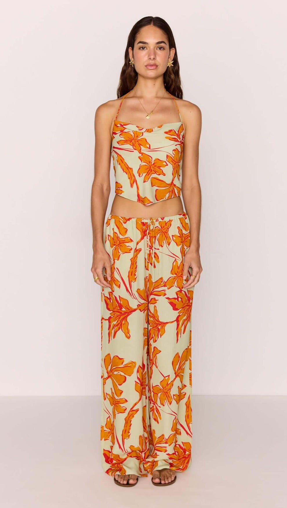Model wearing Green & Orange Floral Drawstring Wide Leg Pant with matching top, showcasing vibrant floral print.