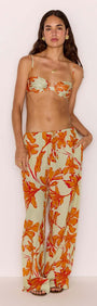 Woman modeling Green & Orange Floral Drawstring Wide Leg Pant and matching top, showcasing resort-style fashion.
