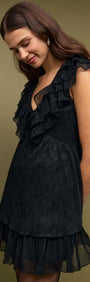 Black Shimmer Plisse Frill Mini Dress on model with layered ruffles and deep V neckline.