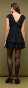 Black Shimmer Plisse Frill Mini Dress back view showcasing layered ruffles and a deep V neckline.