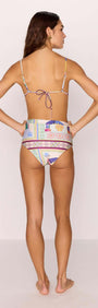 Rear view of a model wearing the Elysia High-Waist Bikini Pant in colorful print, showcasing its retro and modern design.