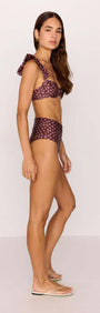 Model wearing a high-waisted bikini pant in burgundy floral print, showcasing a flattering fit and stylish design.