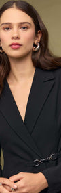 Black Blazer Mini Dress With Buckle Detail worn by a model, showcasing sleek design and modern femininity.