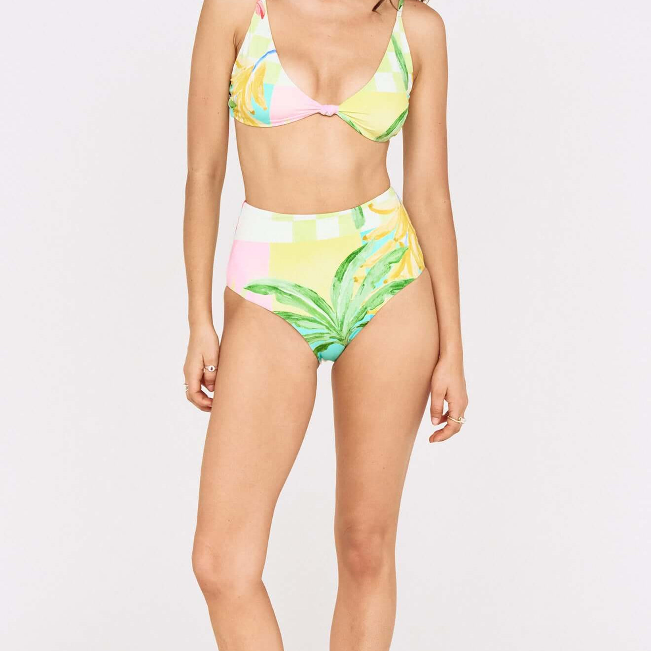 Model showcasing the Palm Print High Waisted Bikini Bottom paired with a matching top, featuring vibrant tropical colors.