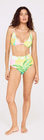 Model showcasing the Palm Print High Waisted Bikini Bottom paired with a matching top, featuring vibrant tropical colors.