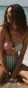 Contrast Stripe Strapless Bandeau with Shell Detail worn by a woman at the beach, showcasing vibrant colors and style.