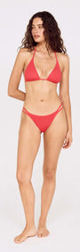 Grapefruit Strappy Bikini Bottom with Shell Detail modeled by a woman in a stylish red bikini.