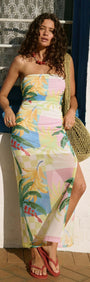 Model wearing Palm Print Mesh Strapless Midi Dress with tropical pattern, standing in sunlight near a window.