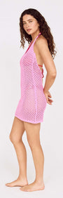 Model wearing a Baby Pink Crochet Mini Dress with Halter Neck, showcasing its stylish design.
