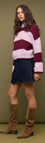 Model wearing Denim Mini Wrap Skirt With Buckle Detail and striped sweater, showcasing a stylish outfit.