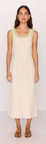Model wearing a white knit midi dress with contrast green trim, showcasing a stylish summer look.