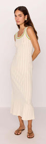 Model wearing a white knit midi dress with contrast green trim, showcasing a stylish summer look.