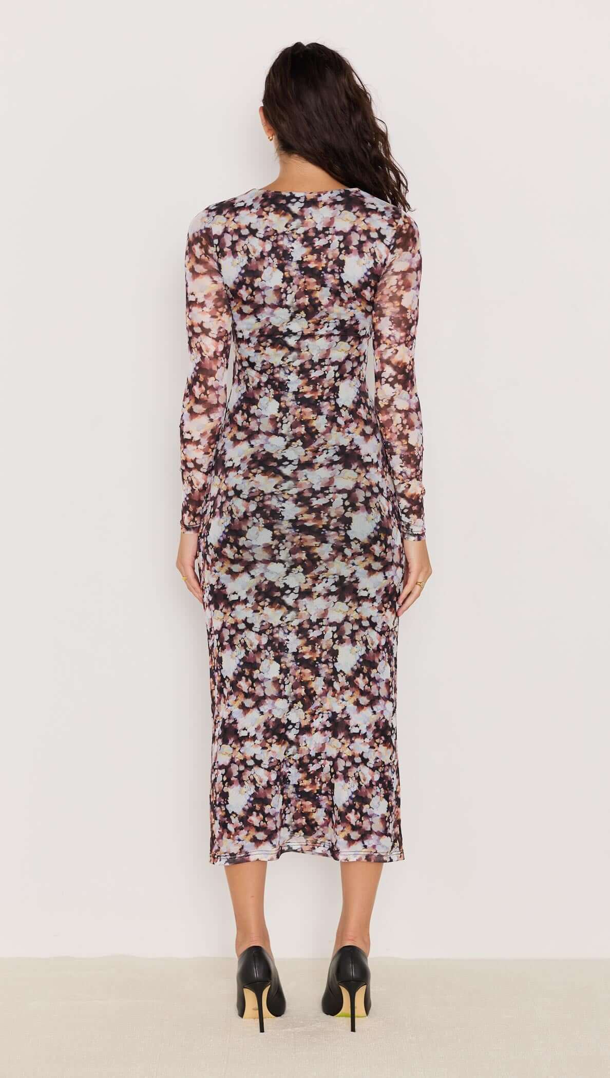 Back view of the Audrey Mesh Midi Dress featuring a blurred floral print and long fitted sleeves.