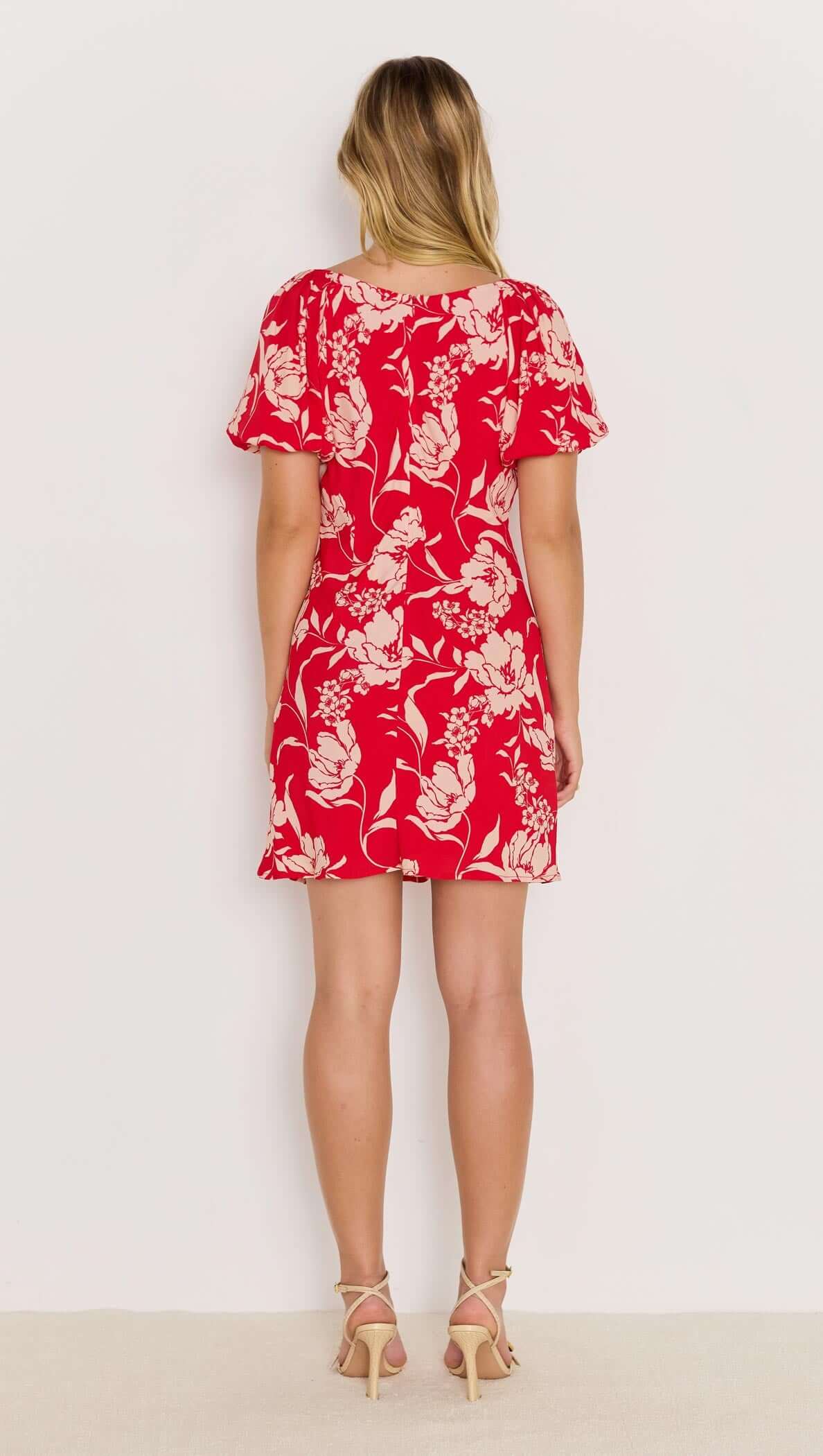 Back view of the Poppy Mini Dress in bold red floral print with floaty short sleeves and mini length.