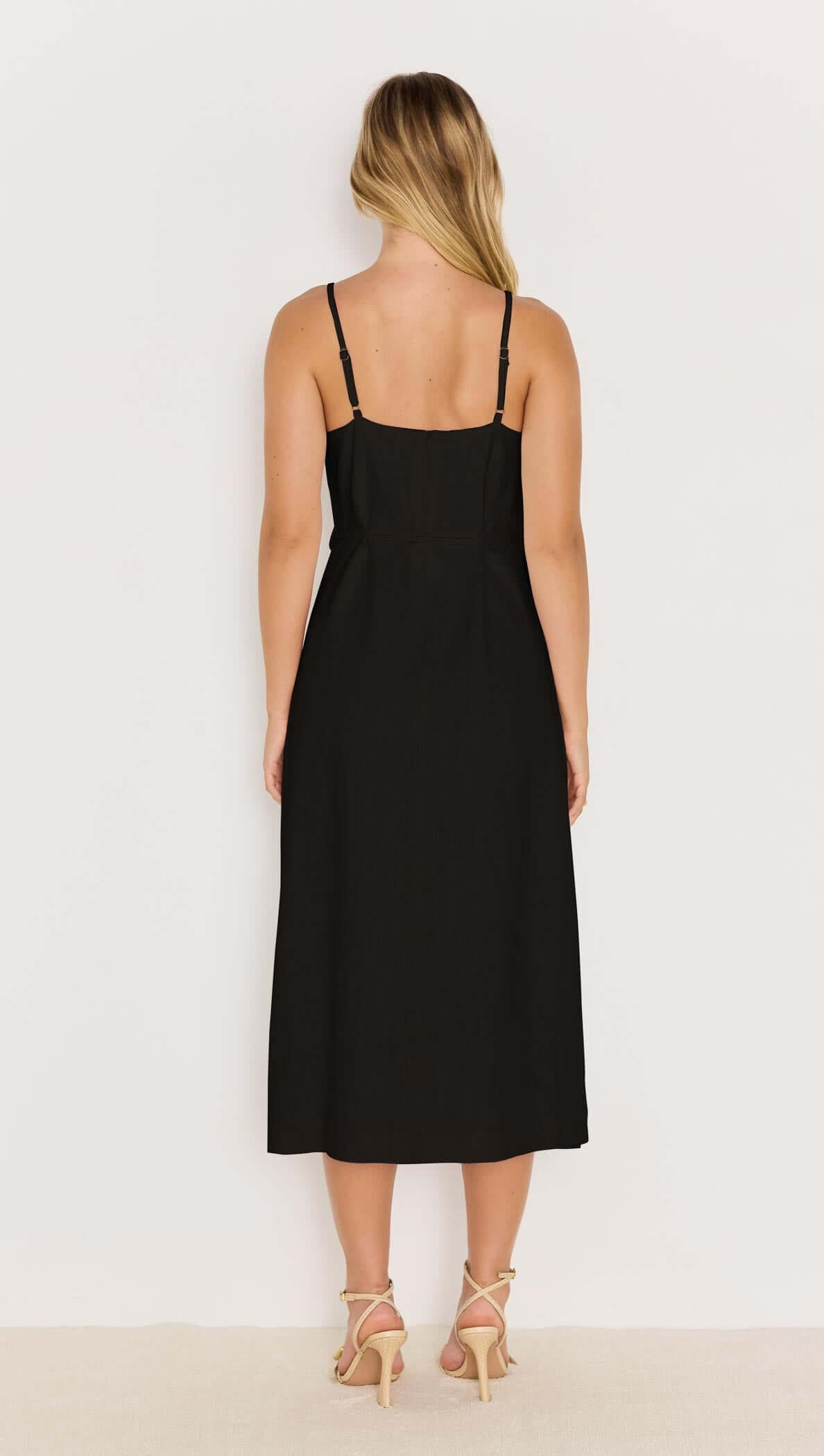 Back view of the Irena Belted Sundress in black with slim adjustable straps and midi length.
