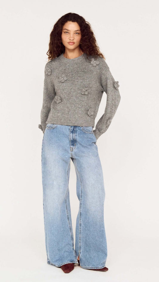 Model wearing Round Neck Grey Floral Applique Jumper with relaxed fit, paired with light blue wide-leg jeans.