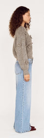 Round Neck Grey Floral Applique Jumper styled with light blue jeans in a side view.