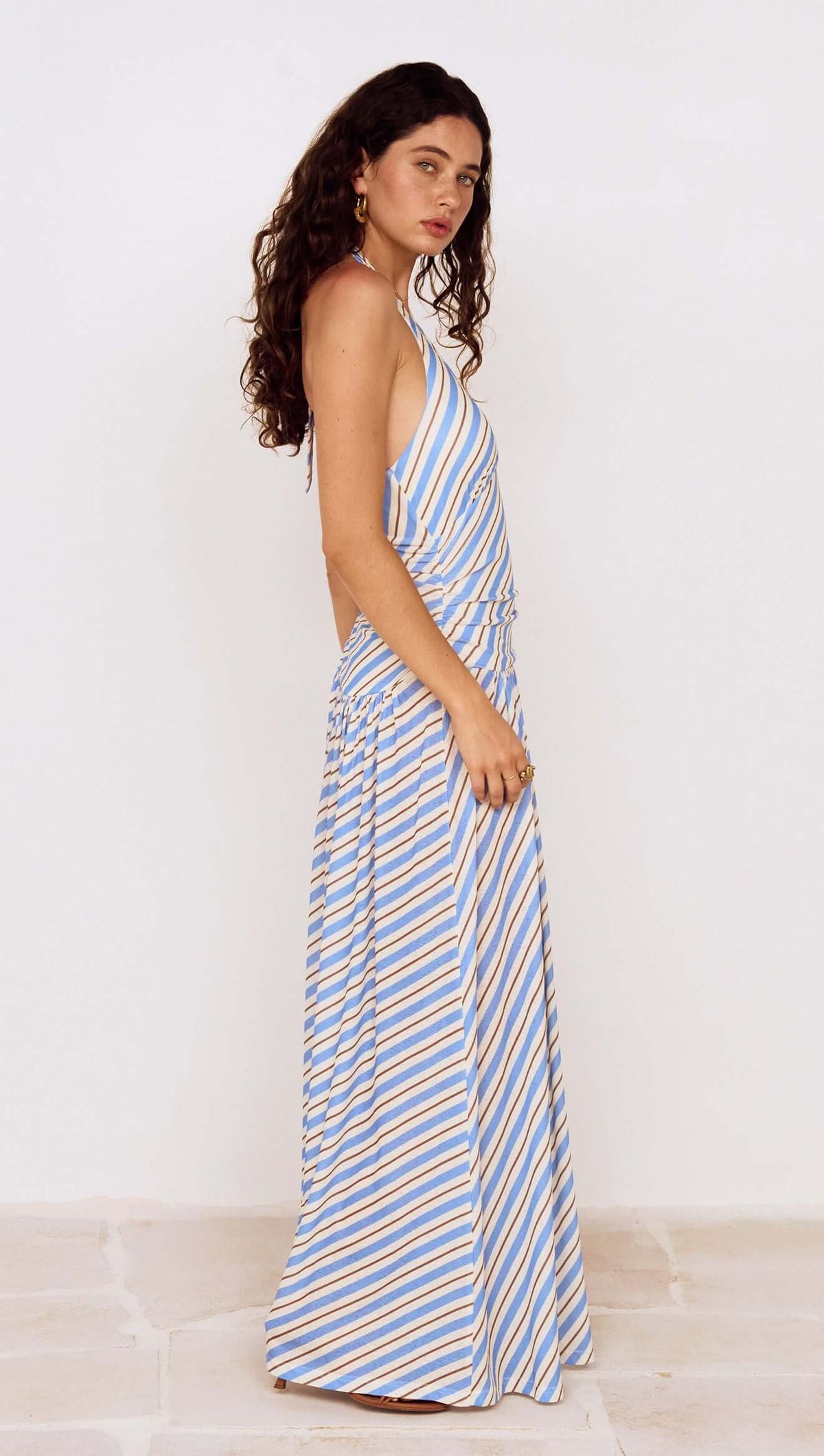 Blue Stripe Halter Neck Midi Dress featuring a side view of the model showcasing the stylish design.