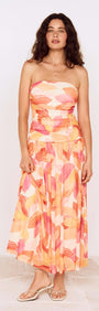 Model wearing a Sunset Leaf Print Sleeveless Midi Dress with a colorful tropical print, perfect for summer occasions.