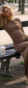 Long Sleeve Mesh Midi Dress with Tie Waist Detail on a model sitting on a bench with a coffee cup.