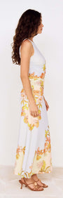 Pastel Floral Sleeveless Midi Dress displayed on a model, showcasing its floral print and ruched silhouette.